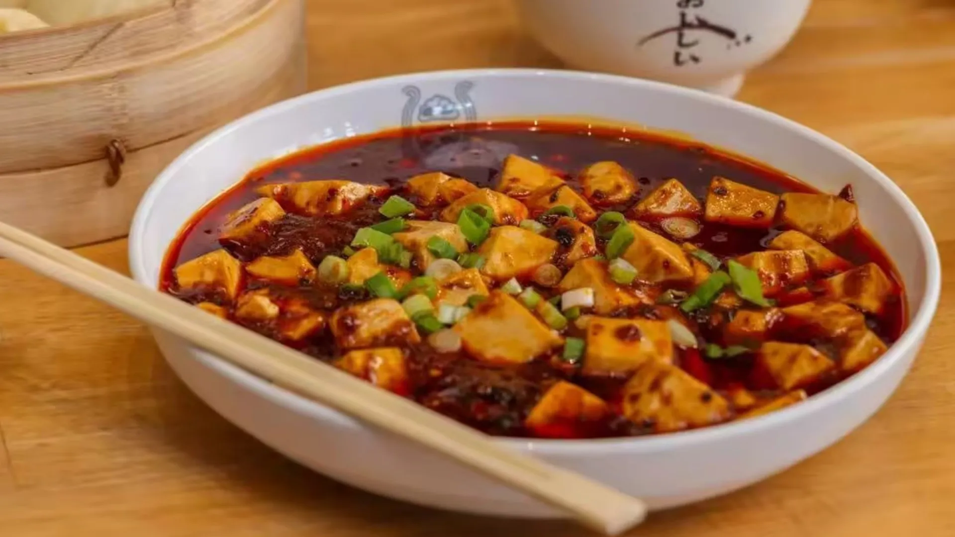 Spicy Mapo tofu in red sauce at TastiGo Kitchen, an Asian Fusion Restaurant in Miami